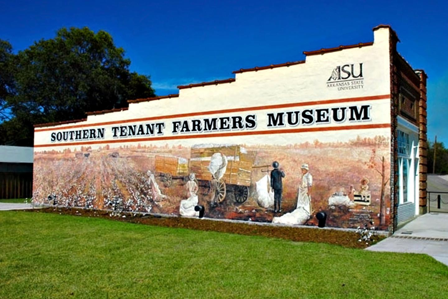 Southern Tenant Farmers Museum with mural on the side, blue sky above.