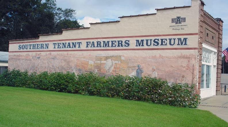 Southern Tenant Farmers Museum with mural, surrounded by greenery.