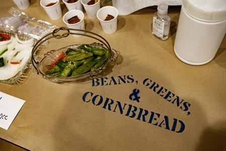 Tray of sliced okra and peppers, with "Beans, Greens, &amp; Cornbread" on brown paper.
