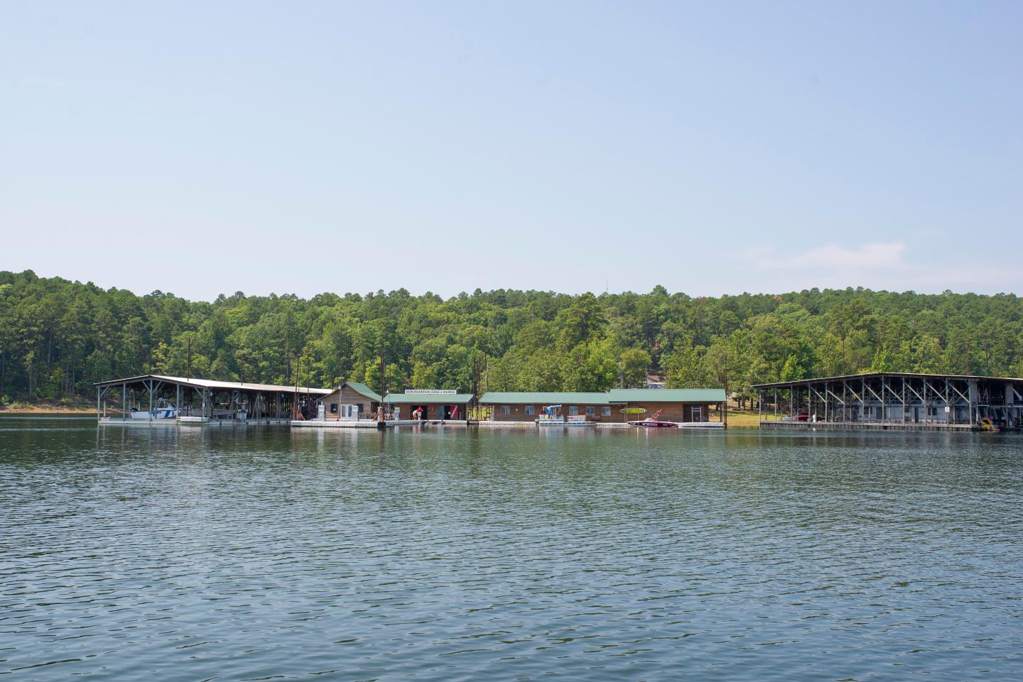 Lake with docks and forested shoreline.