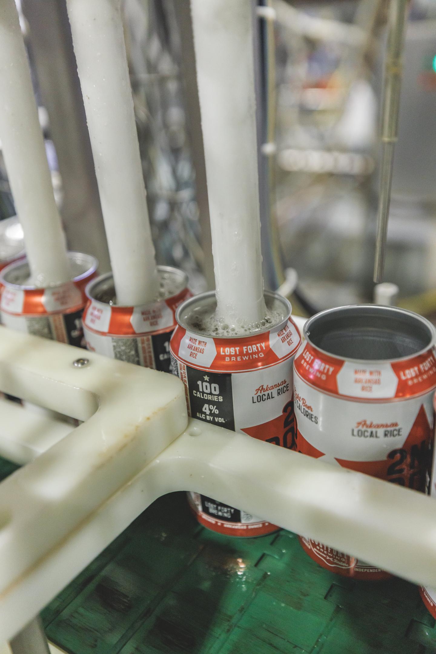 Lost Forty cans being filled on an assembly line.