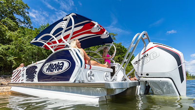 Luxury pontoon boat with canopy on a sunny lake.