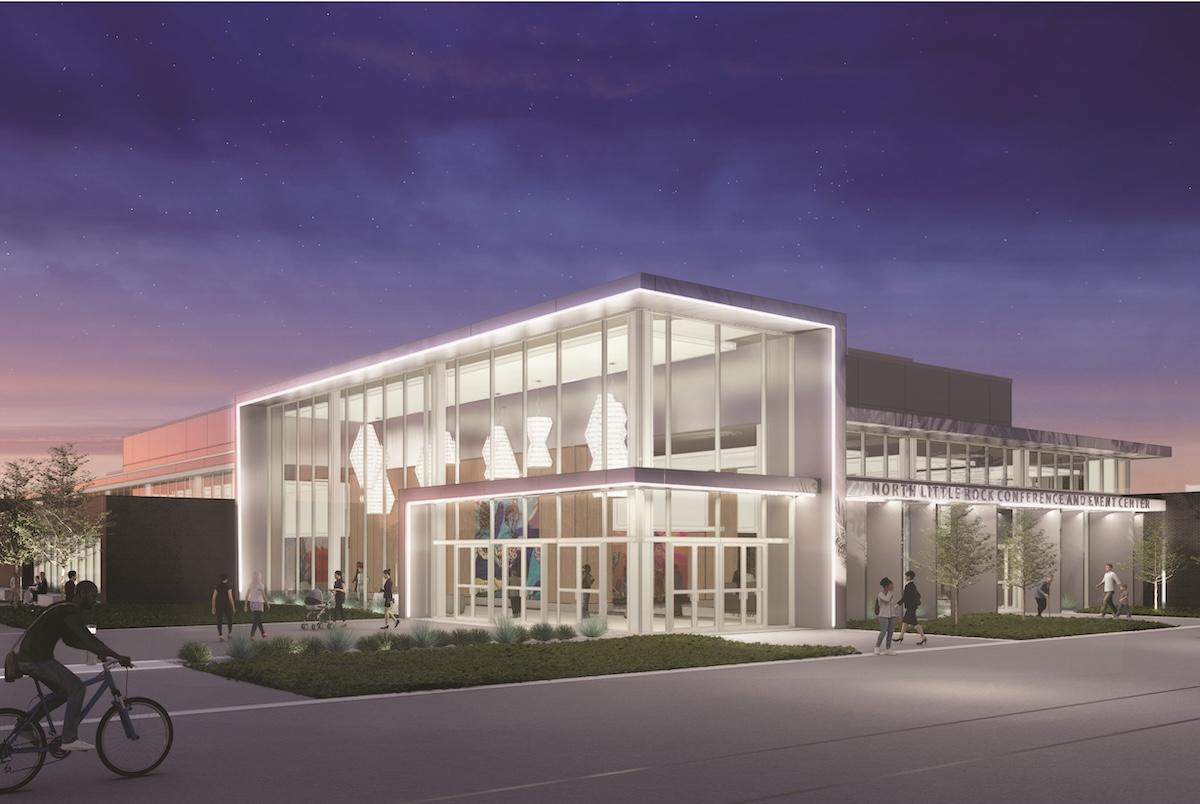 Modern building with glass facade lit at dusk.
