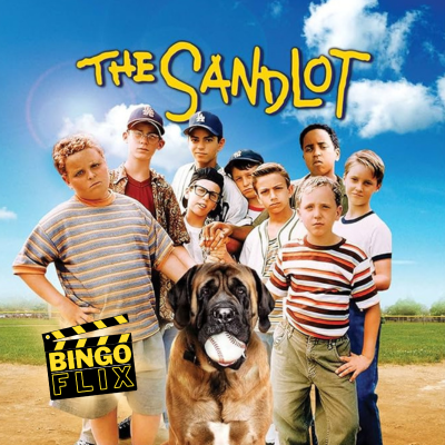 Boys in casual clothing stand on grass with a big dog in front, bright blue sky above.