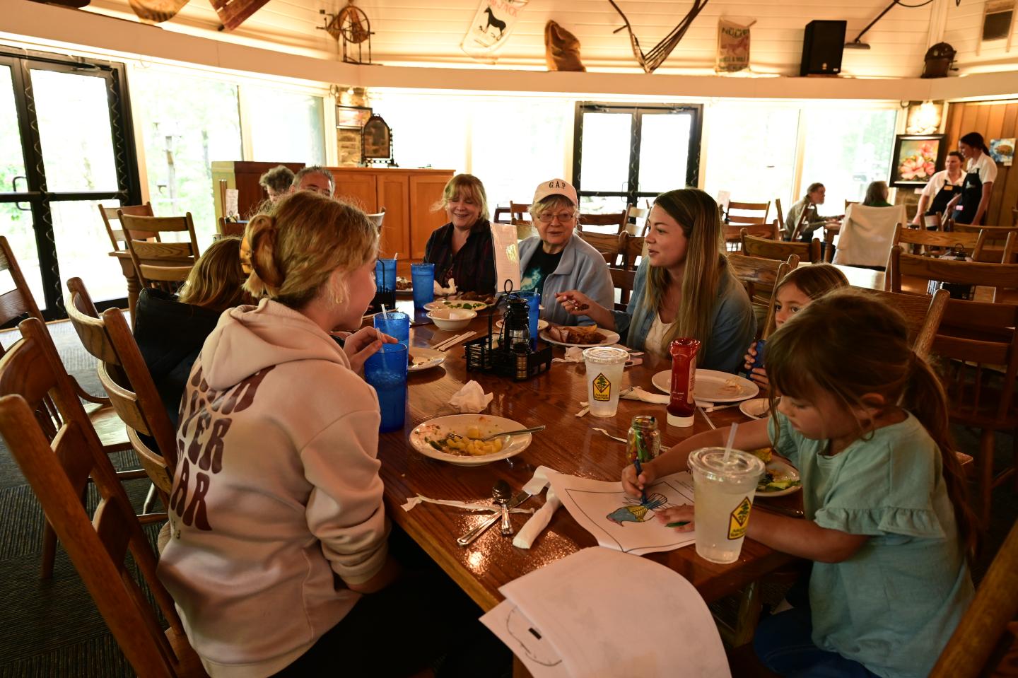 Family dining at a restaurant table, enjoying a meal.