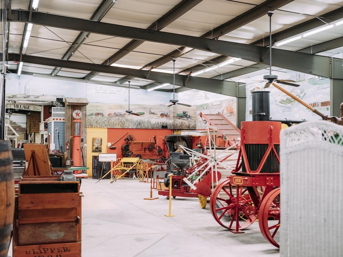 Historical museum displays vintage farming equipment.