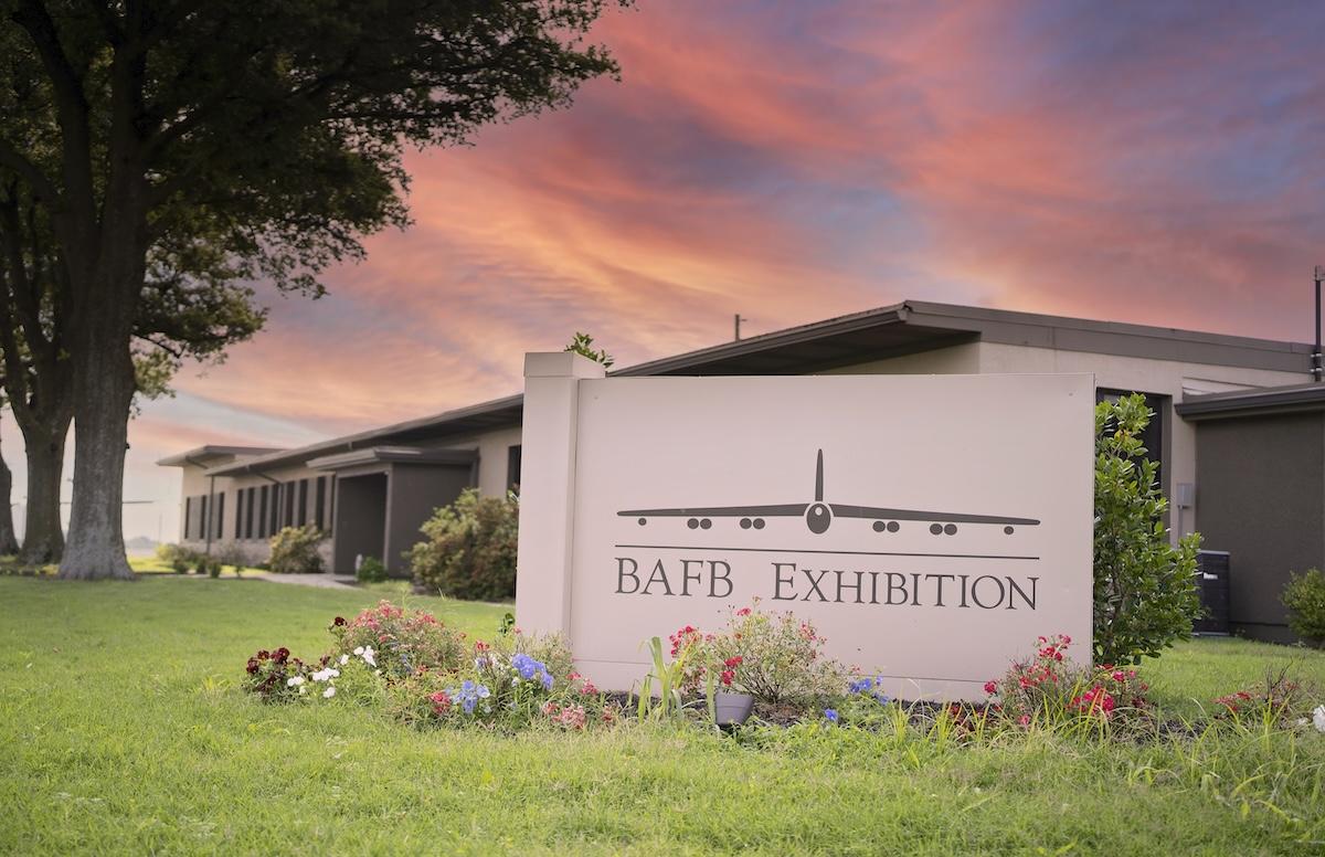 BAFB Exhibition sign by a building at sunset.
