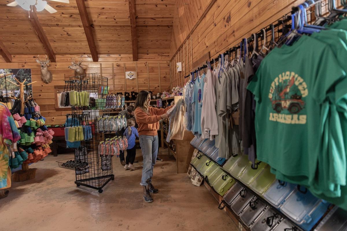 Cozy wooden shop interior with clothing and colorful merchandise displays.
