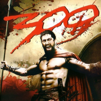 Warrior in red cape holding a spear, shouting in battle stance.