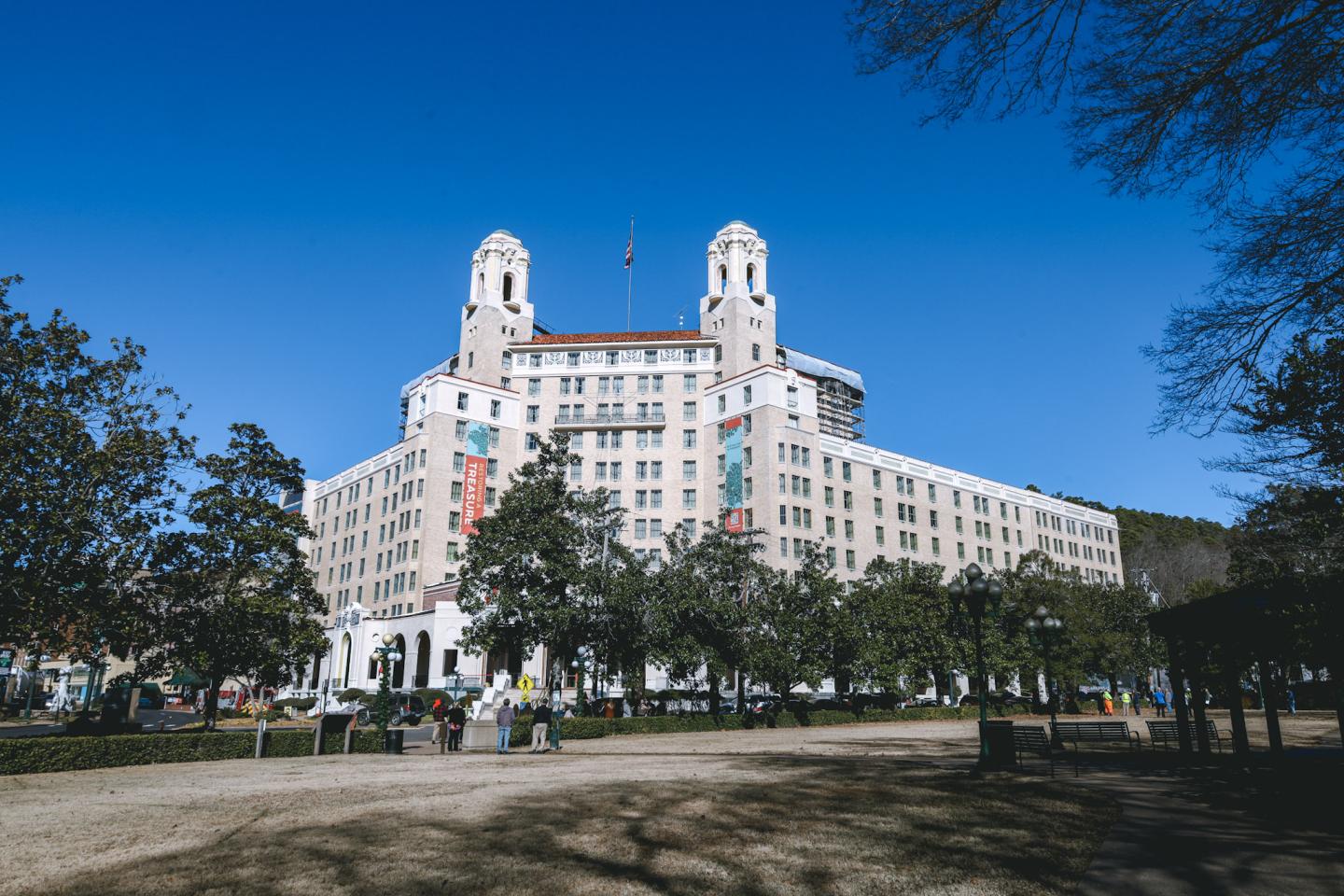 Large historic hotel with twin towers, clear blue sky.