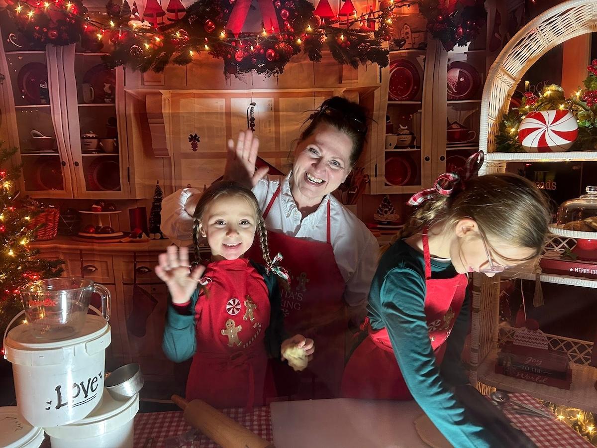 Family baking in festive kitchen, surrounded by holiday decorations.