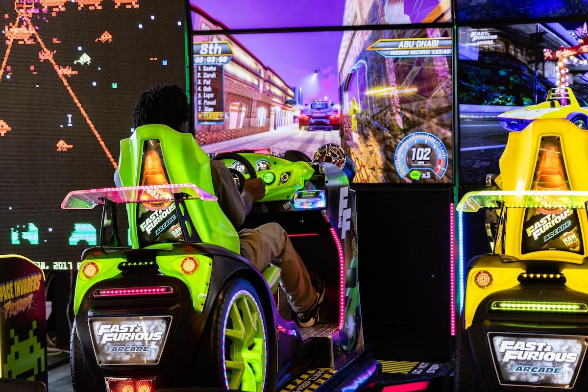 Racing arcade game with neon colors and car driving simulation.