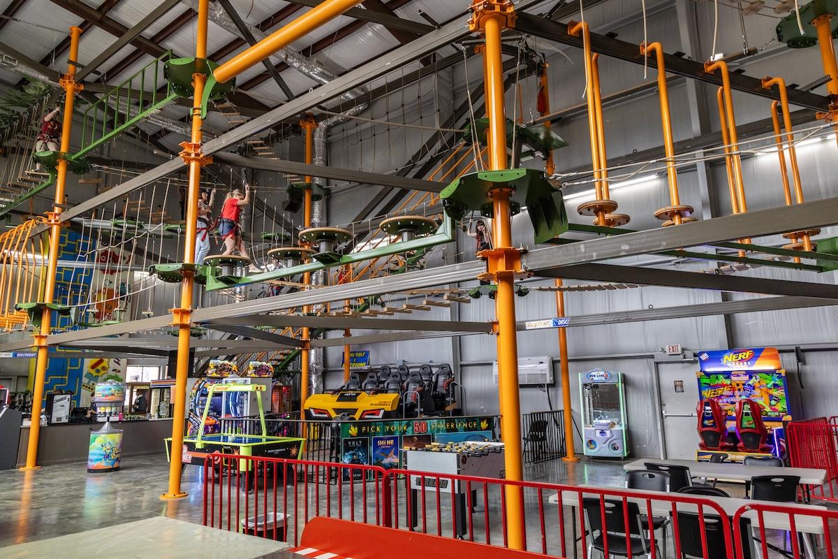 Indoor adventure park with ropes course and arcade games.