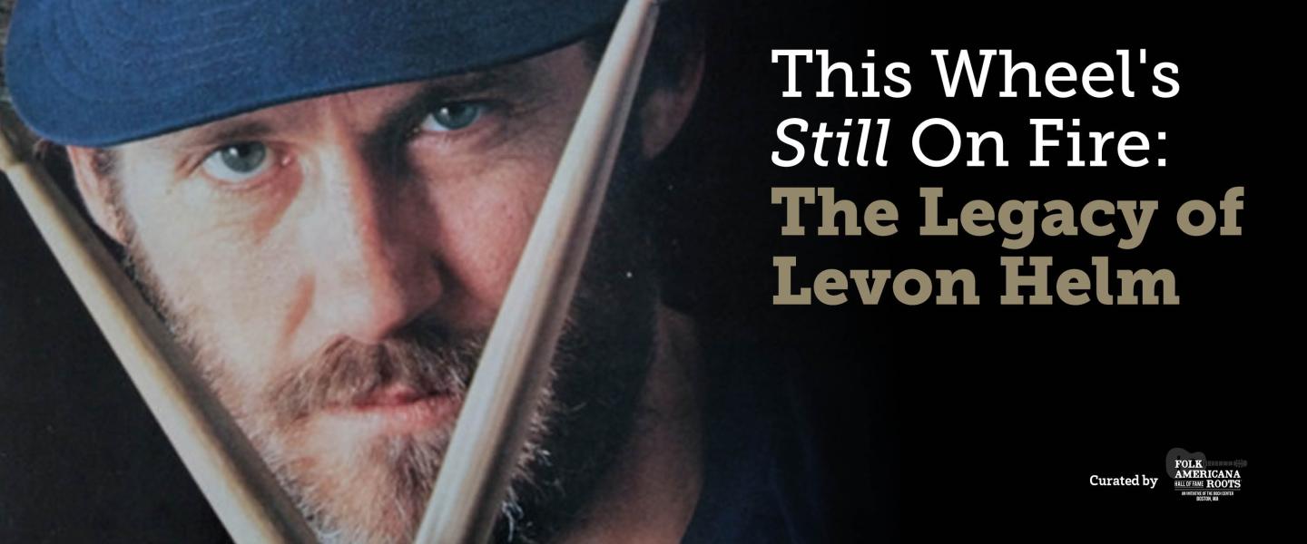 Close-up of a man with drumsticks, text on the right side.