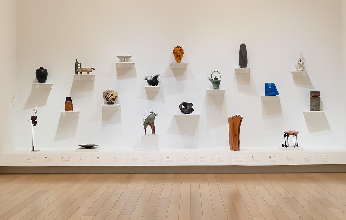 Art gallery wall with various ceramic sculptures on display.