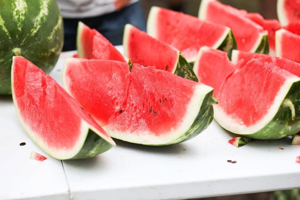 Watermelon slices on a white table.