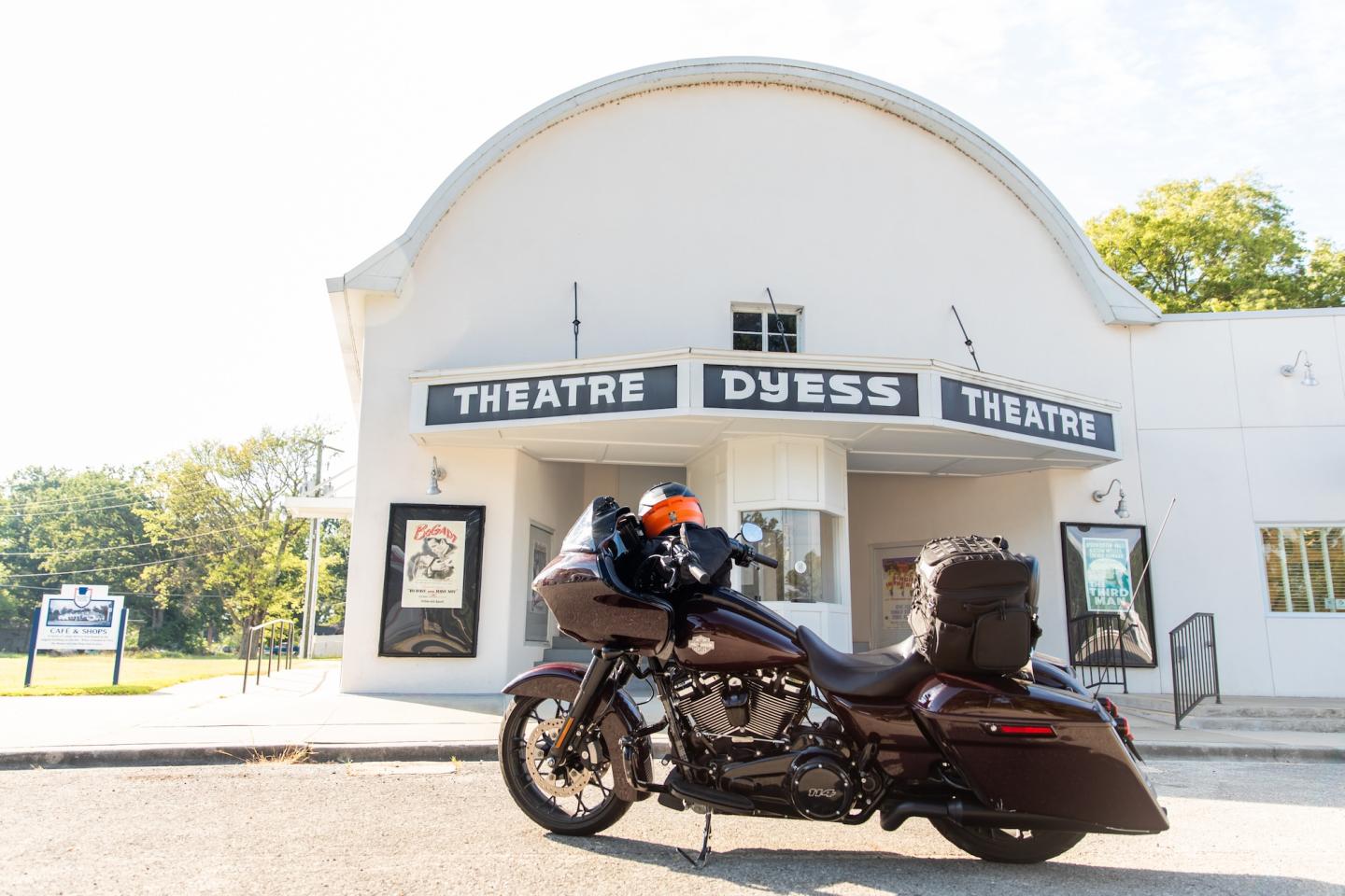 Motorcycle parked in front of a vintage theater.