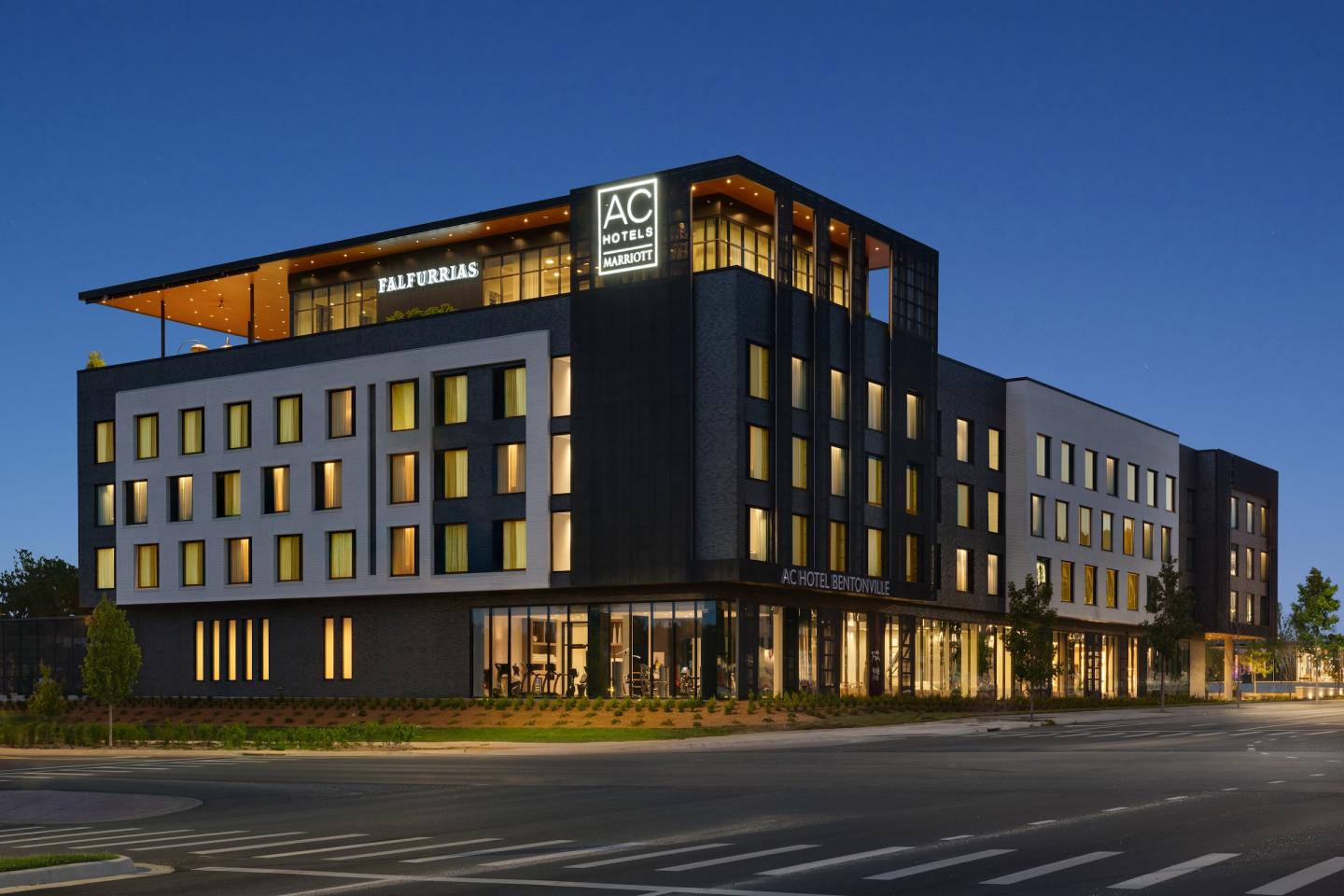 Modern hotel building illuminated at night with sleek design.
