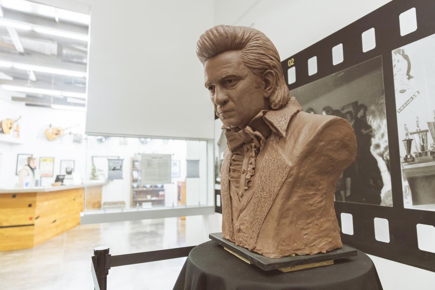 Bust sculpture in an art gallery with film strip decor.