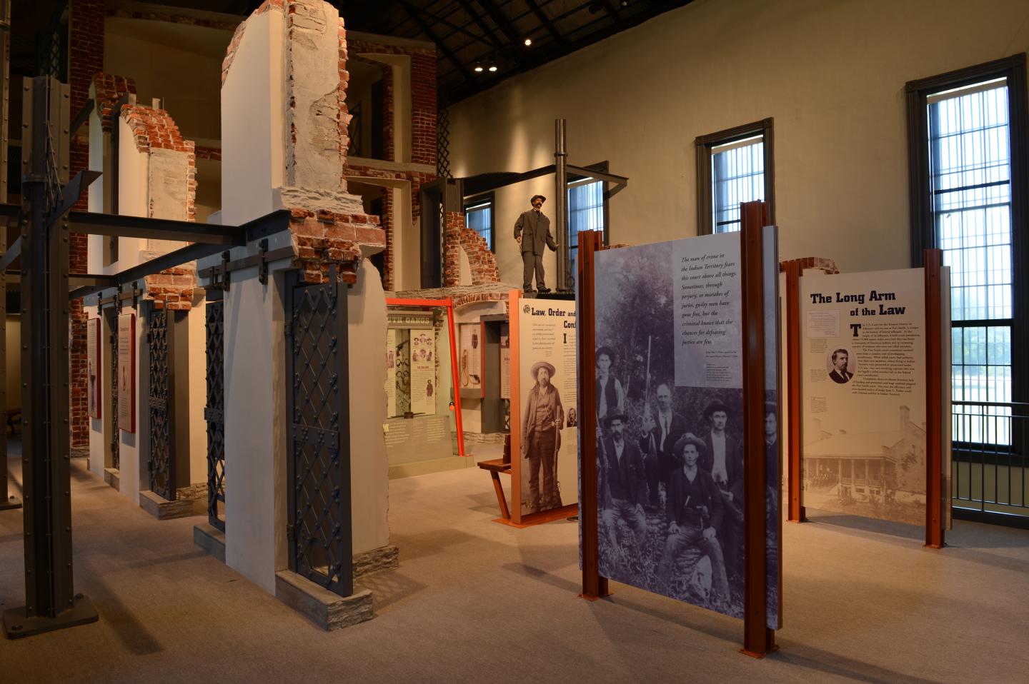 Museum exhibit with historic machinery and informational panels in a warmly lit hall.