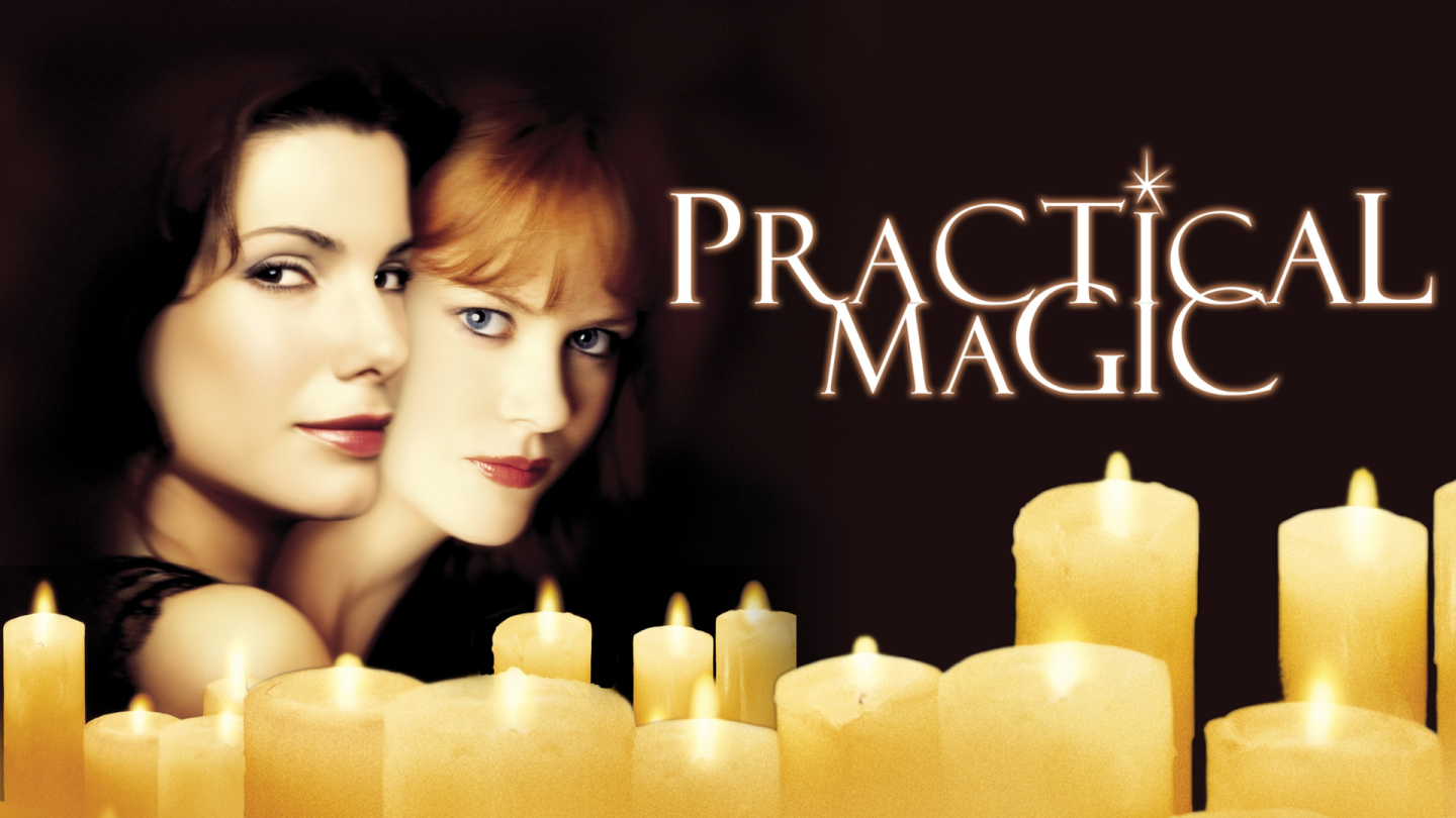 Two women behind glowing candles beside the title “Practical Magic”