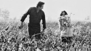 Johnny Cash and wife June Carter Cash in the fields near Cash's boyhood home in Dyess
