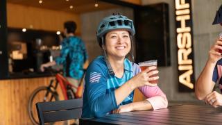 Biker enjoying a brew at Coler Mountain Bike Preserve in Bentonville
