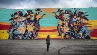 Colorful mural of cowboys