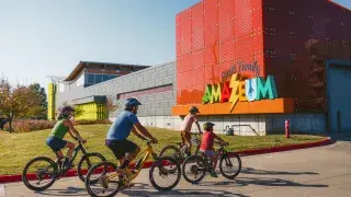 family biking to the Scott Family Amazeum