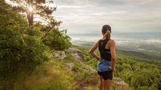 Female hiker stops on hike to take in the scenery
