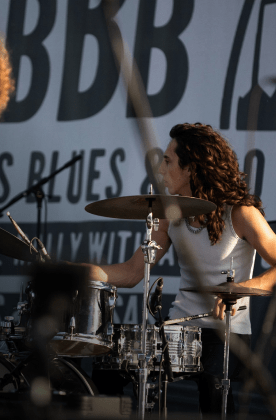 woman playing drums on stage