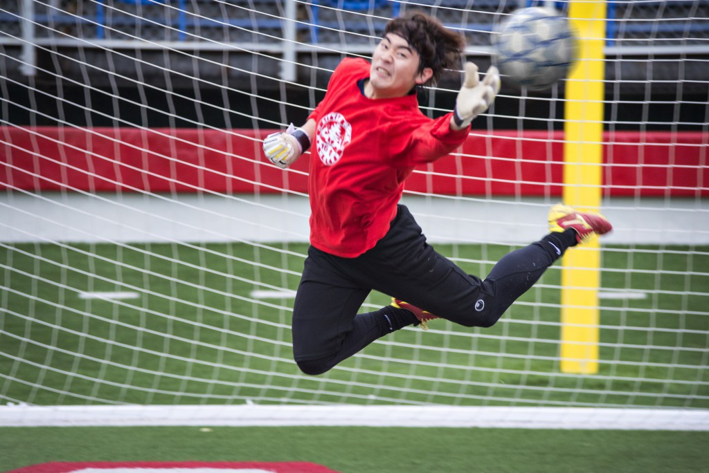Goal-keeper Satoshi Tanaka jumps to make a catch