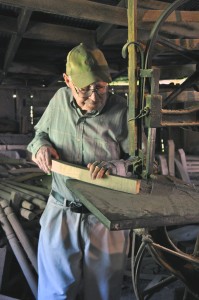 Dallas Bump bores holes in the wood using a boring machine made by his father, Fred Bump, in the 1800s.
